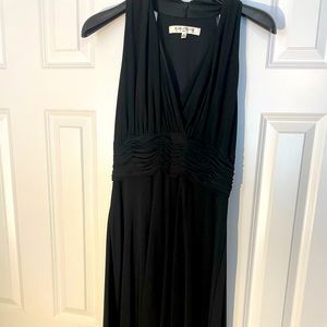 Black A-line cocktail dress with slimming waist.